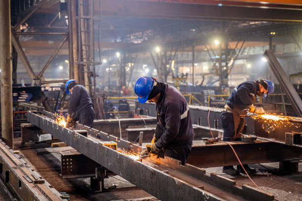 Metal Workers Using A Grinder